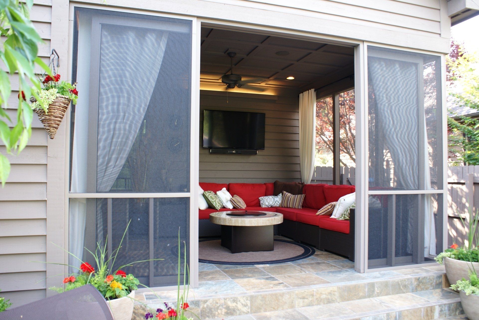 A screened in porch with a couch and a table