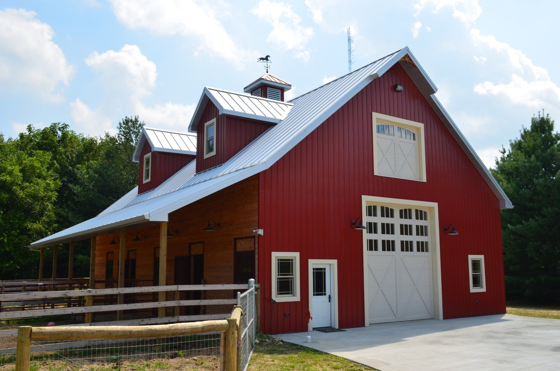 A horse stable with a saddle hanging on the wall.
