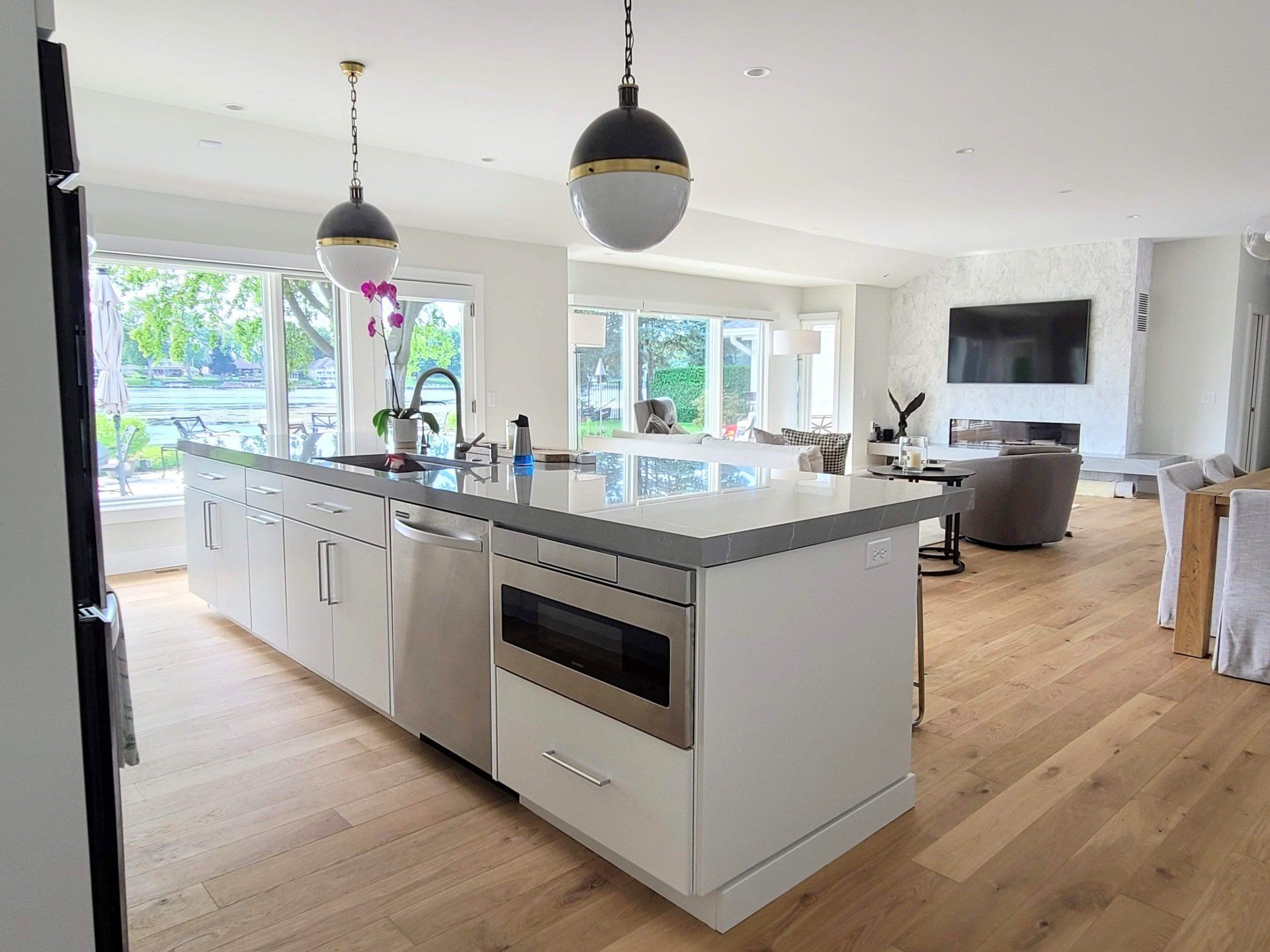 A kitchen with a large island and stainless steel appliances.
