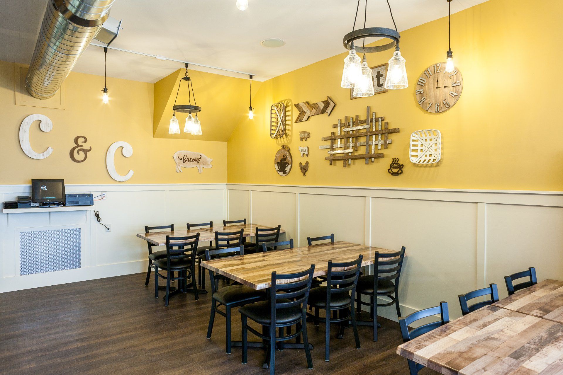 A restaurant with tables and chairs and a clock on the wall.