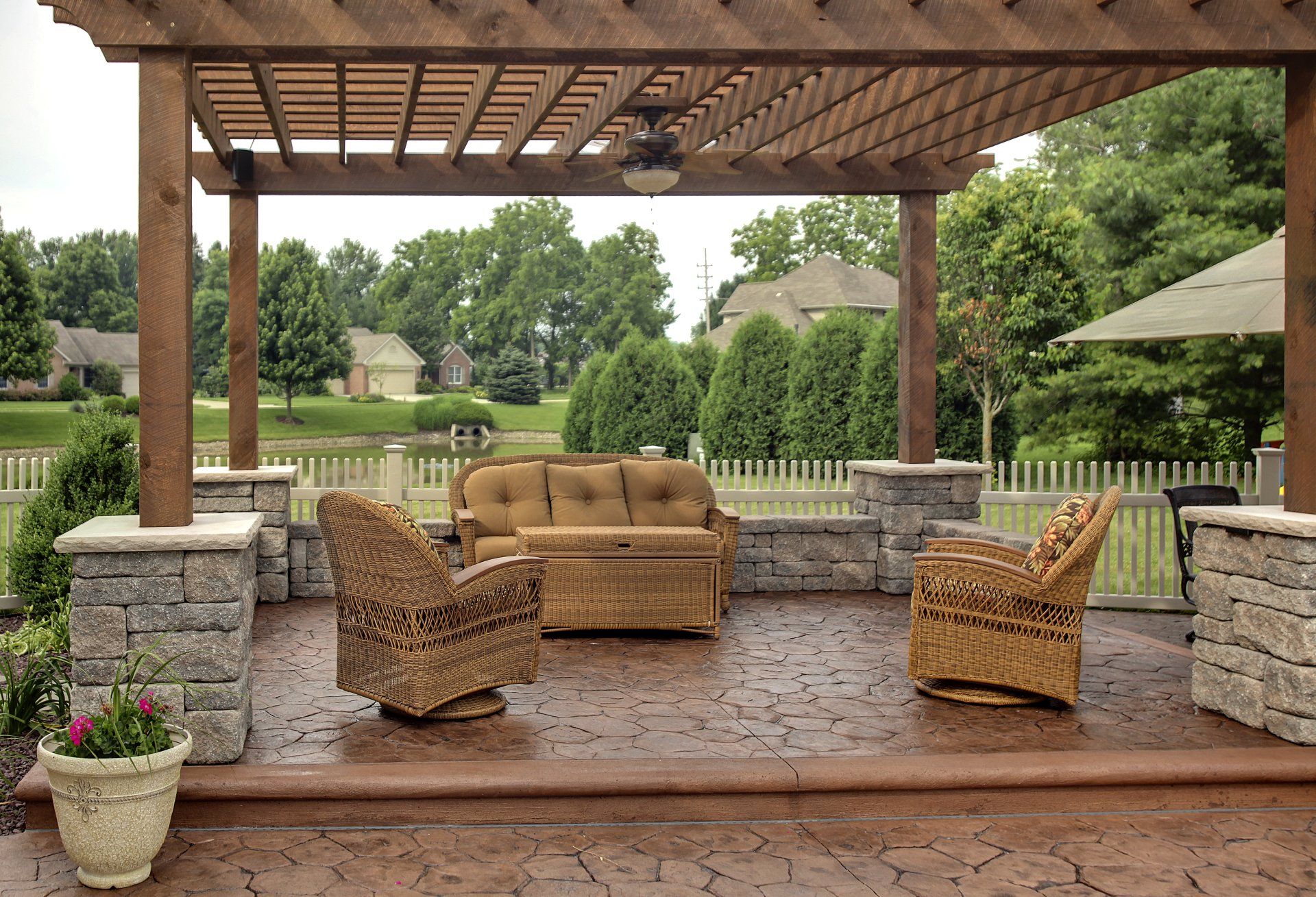 A fire pit surrounded by chairs and tables in front of a house