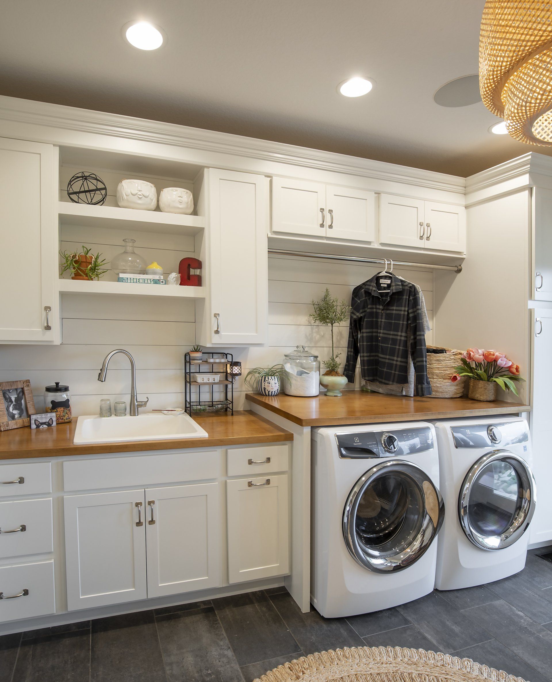 A laundry room with a washer and dryer and a sink