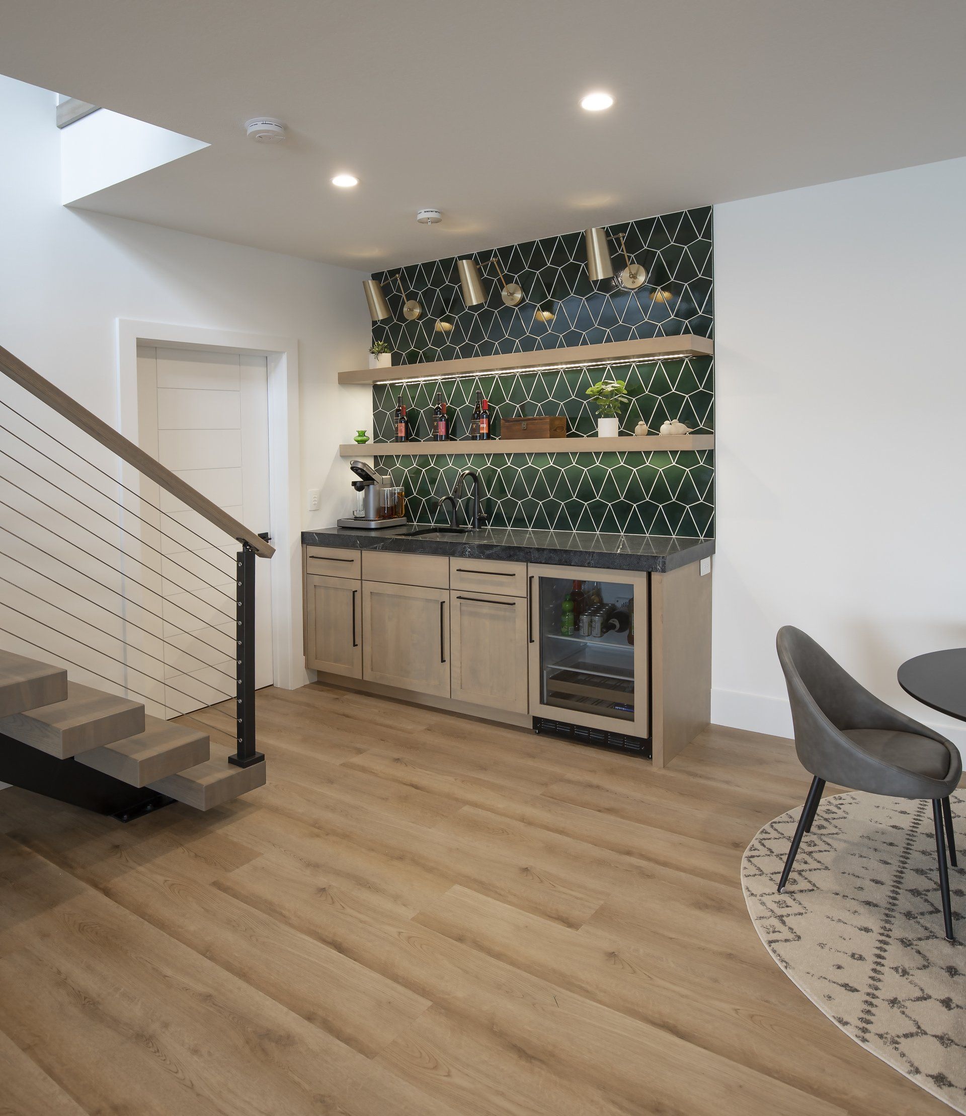A kitchen with a staircase leading up to the second floor