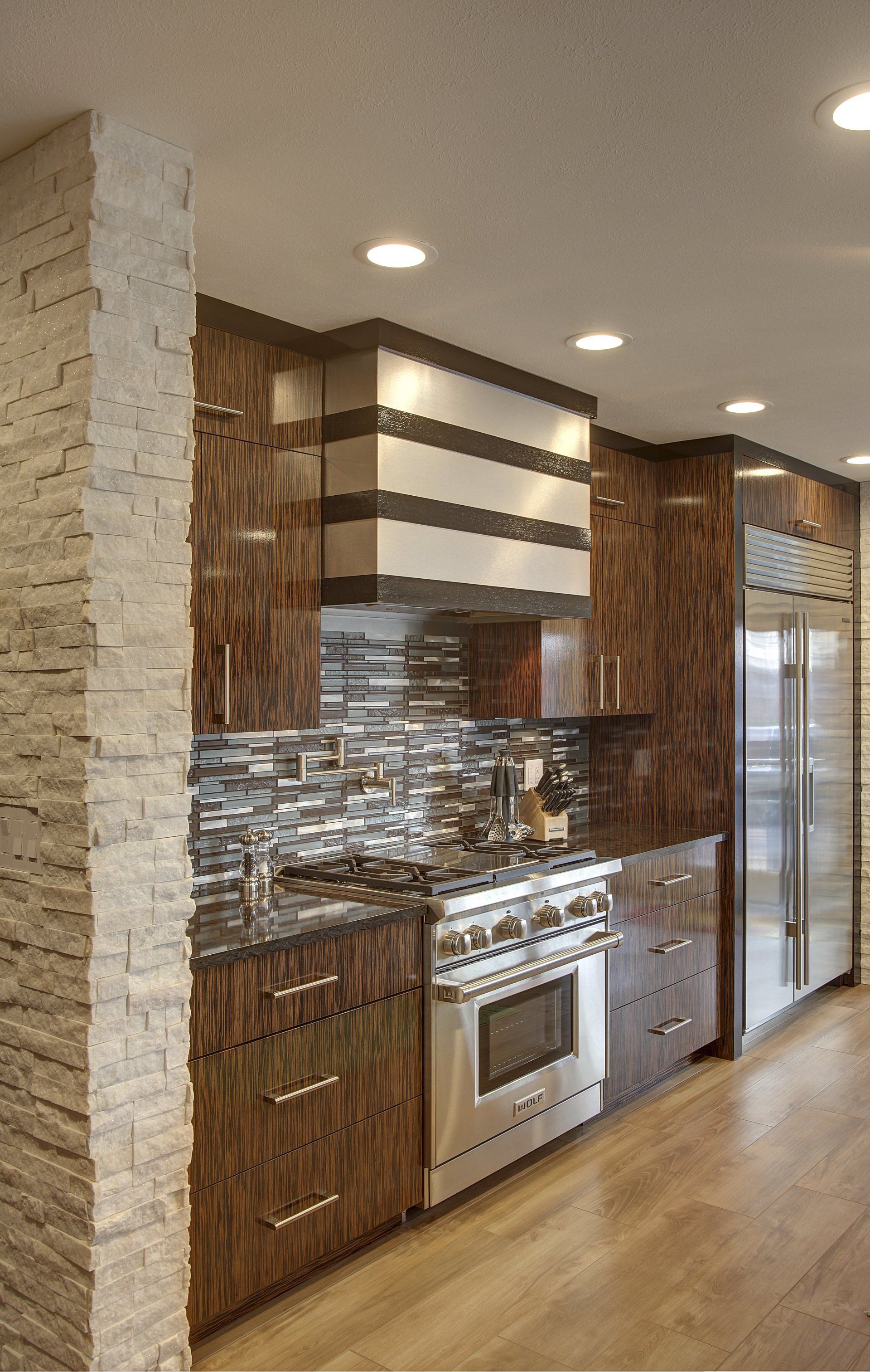 A kitchen with stainless steel appliances and wooden cabinets