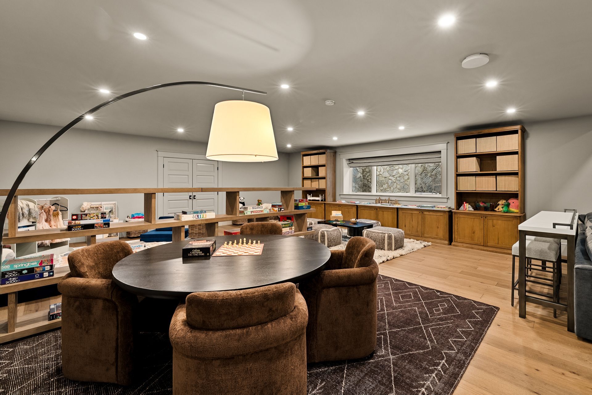 A living room with a large sectional couch and a yellow coffee table