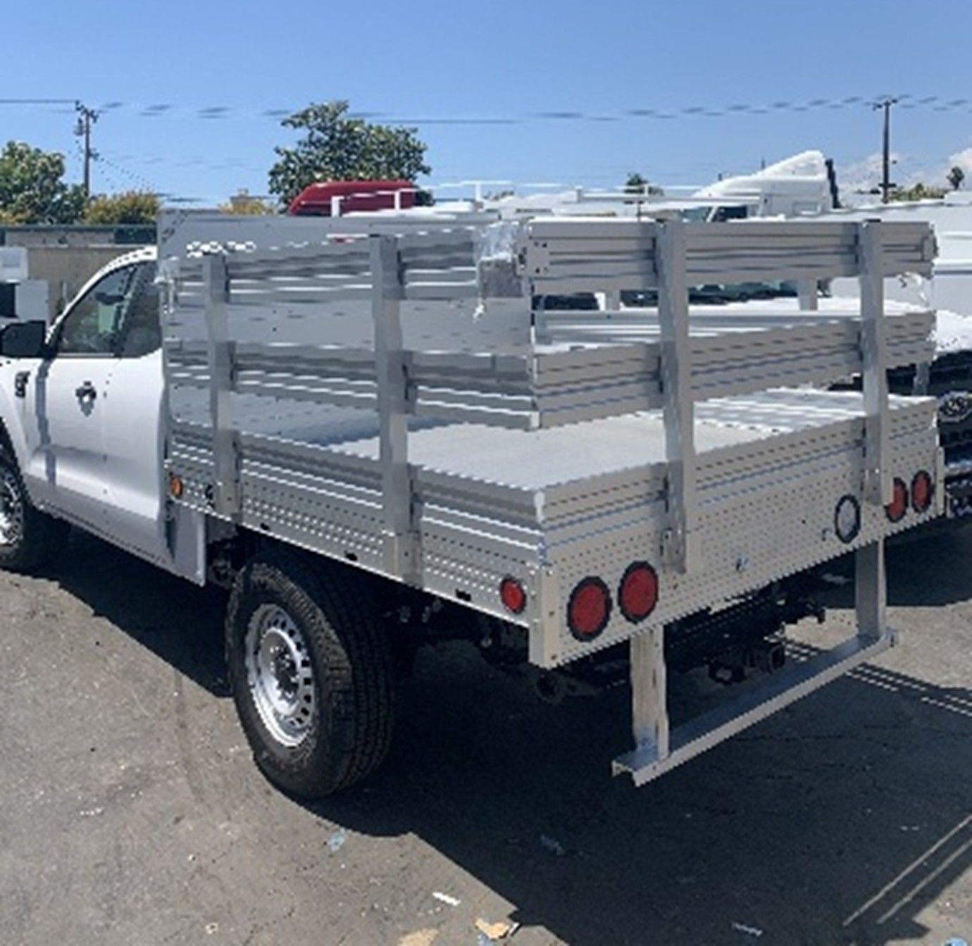 White stake bed truck with metal sides. White stake bed truck with metal sides.