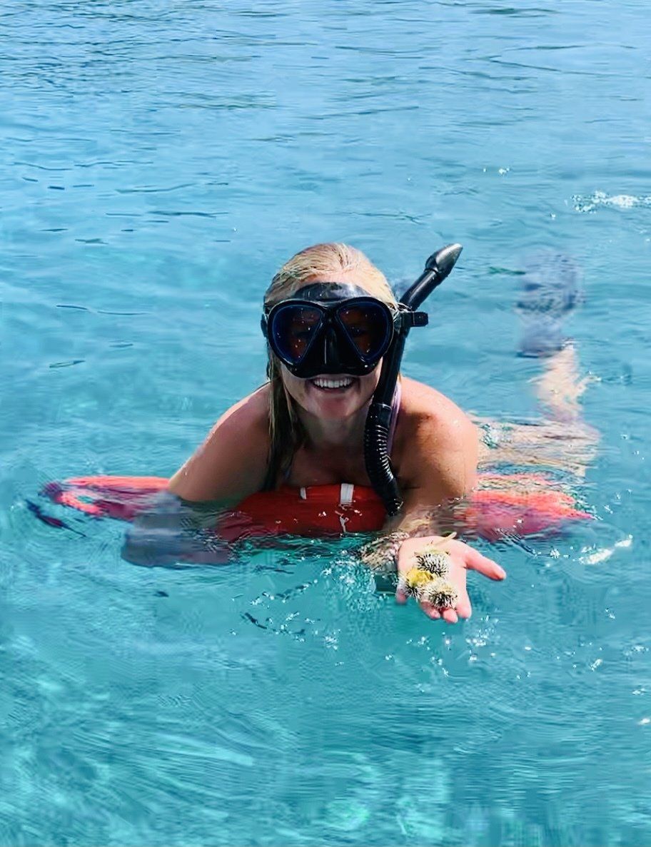 A woman smiling while on the water