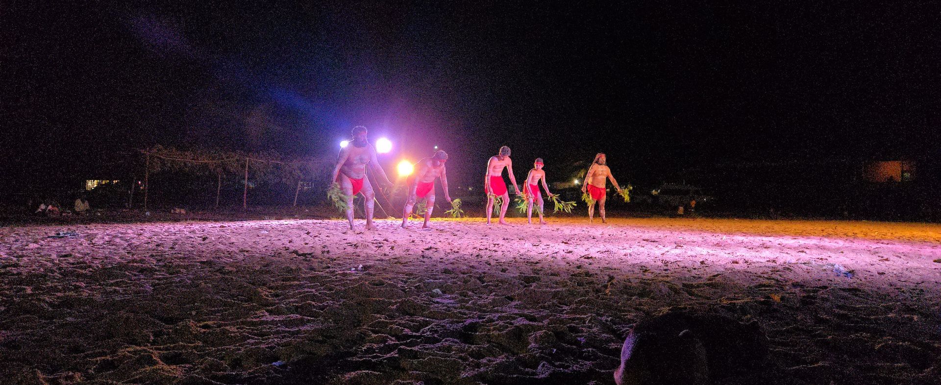 5 people standing in a line dancing