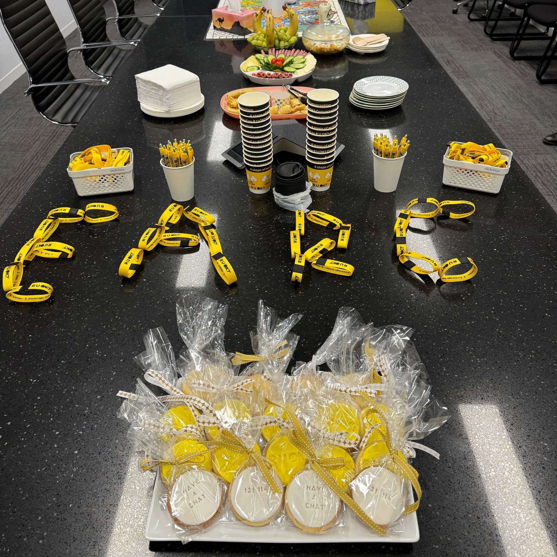 A table with cooking and R U OK? merchandise