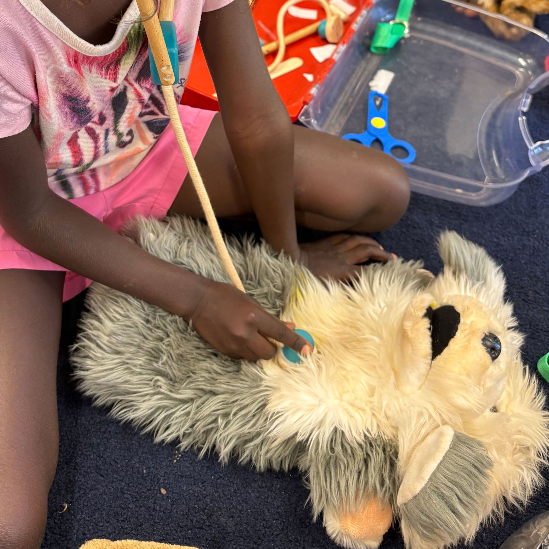A kid playing with a toy dog