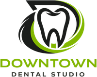 Downtown Dental Studio logo with stylized tooth in black, white, and green