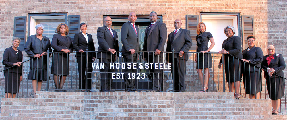 Group posed on steps in front of Van Hoose & Steele building, with