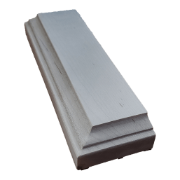 a long white piece of wood is sitting on a white surface .