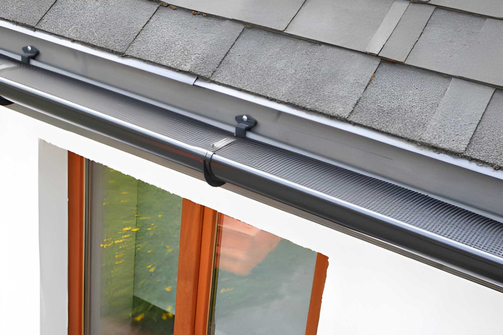 Retractable awning mounted above a window on a house exterior