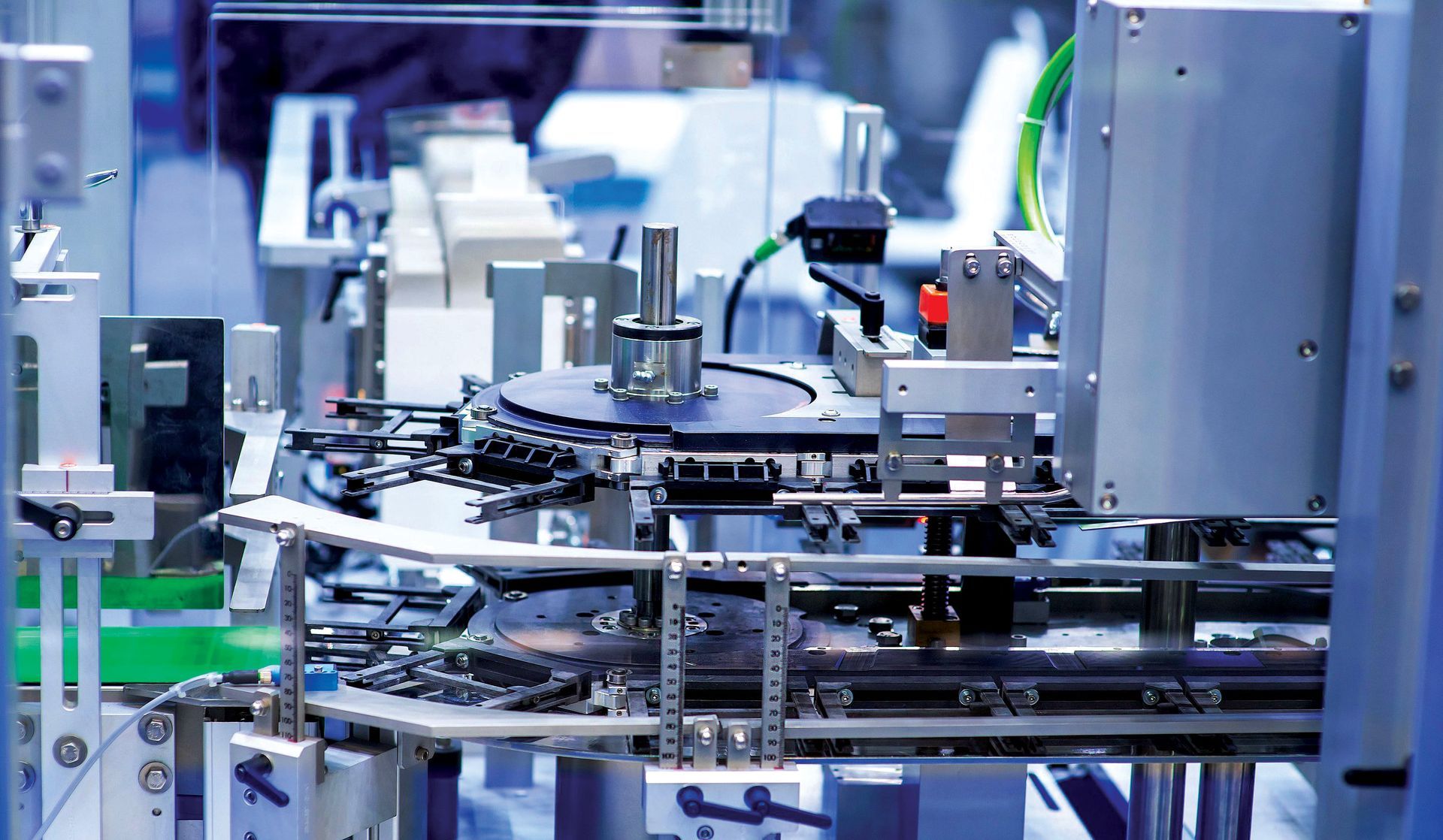 Industrial assembly line with robotic machinery and metal conveyor equipment in a factory setting