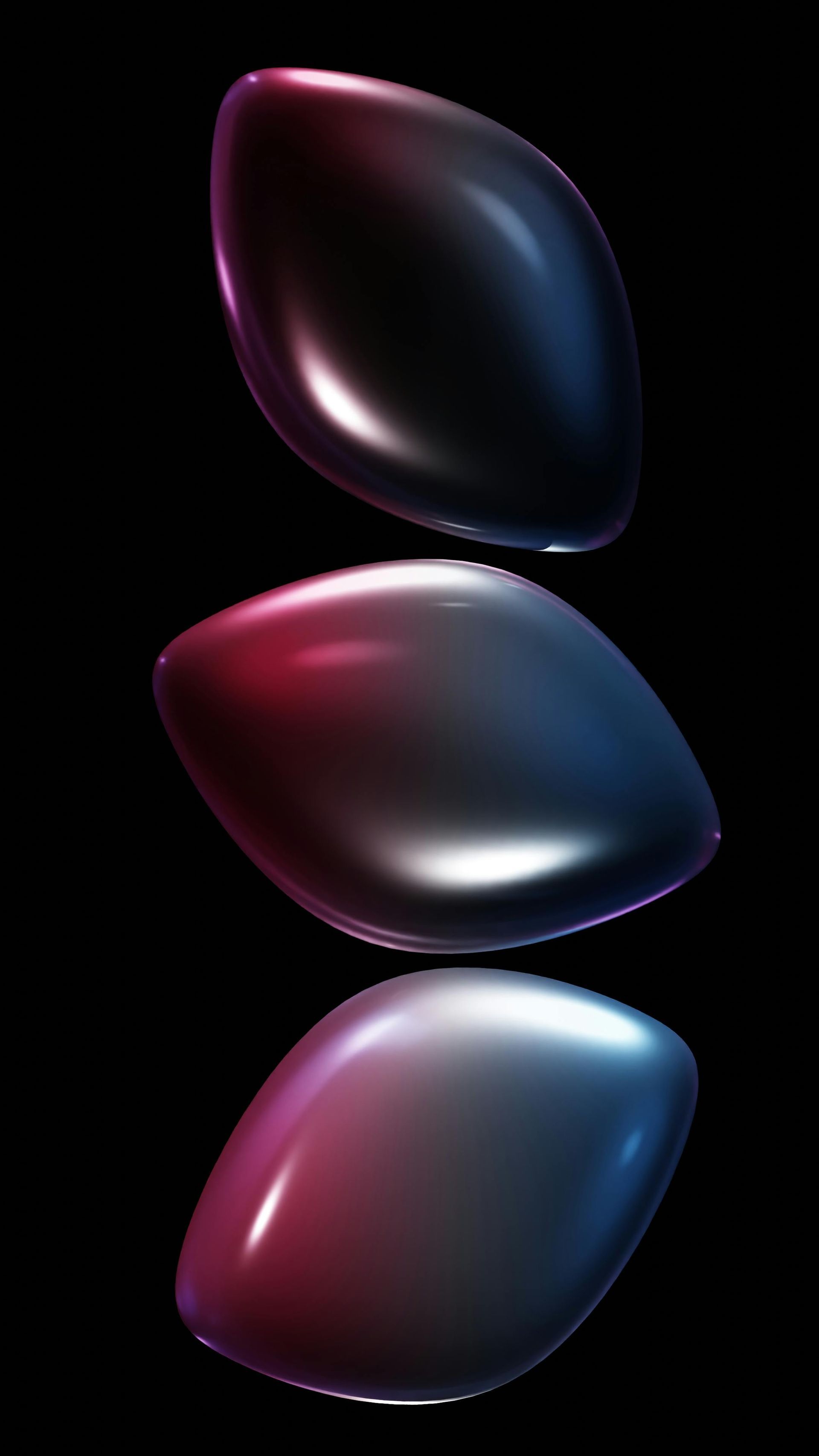 Three glossy, iridescent abstract ovals stacked vertically on a black background.
