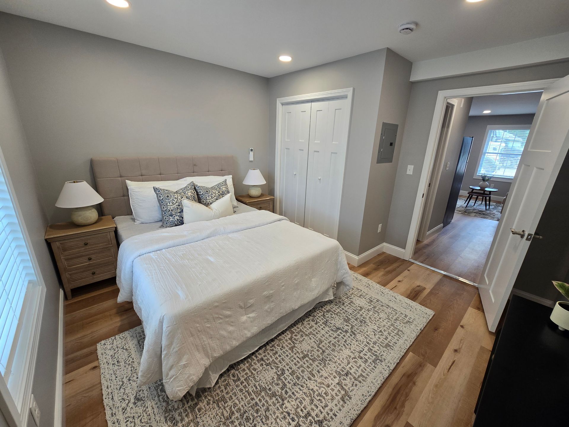 Interior photo of 371 Elm St bedroom with a bed , nightstands , lamps and a rug.