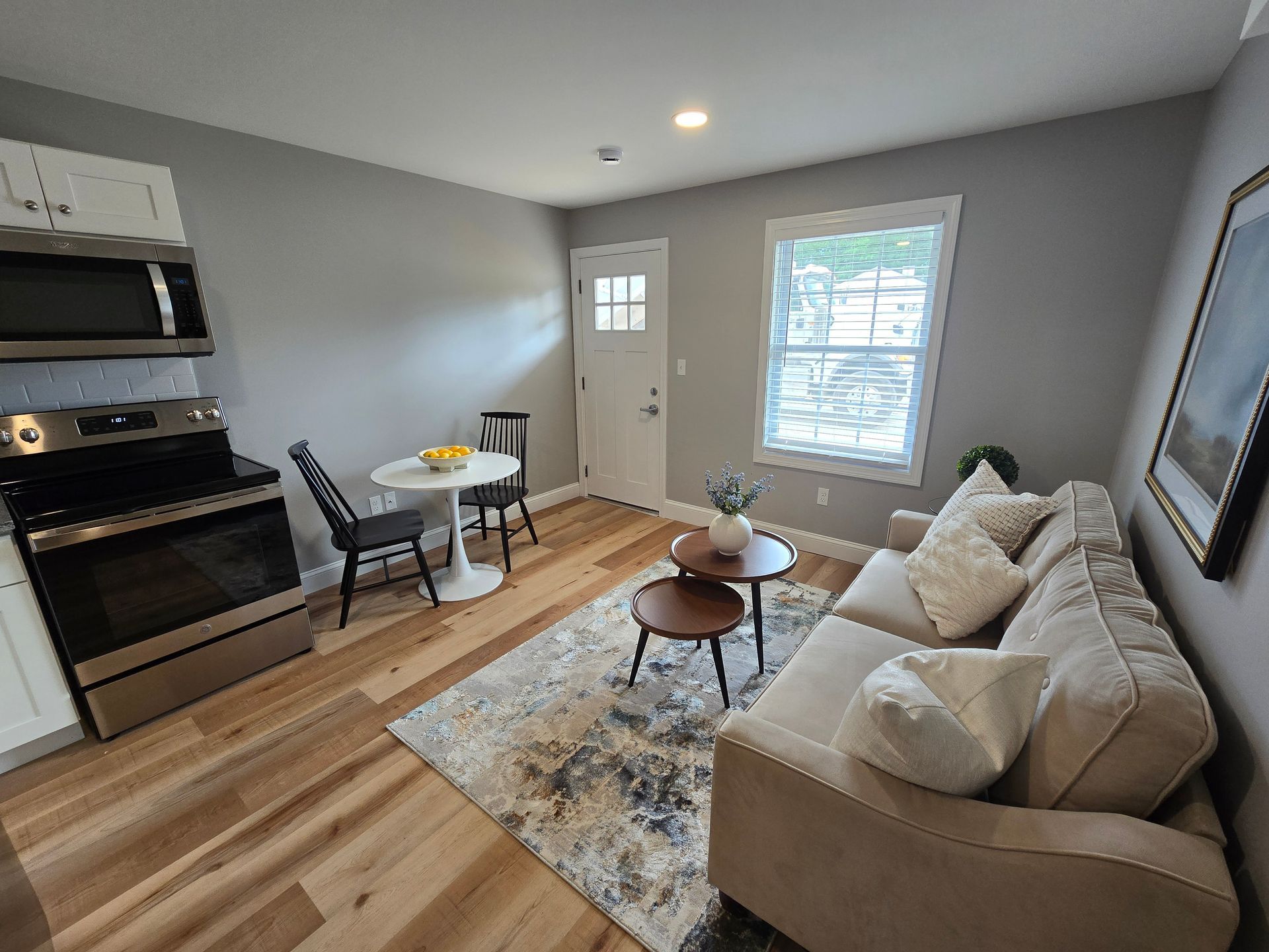 Interior photo of 371 Elm St living room with a couch , table , chairs and a stove.
