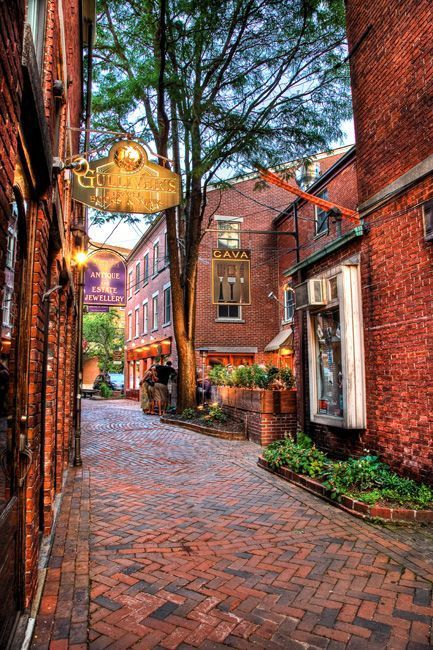 A narrow alleyway between two brick buildings in a city
