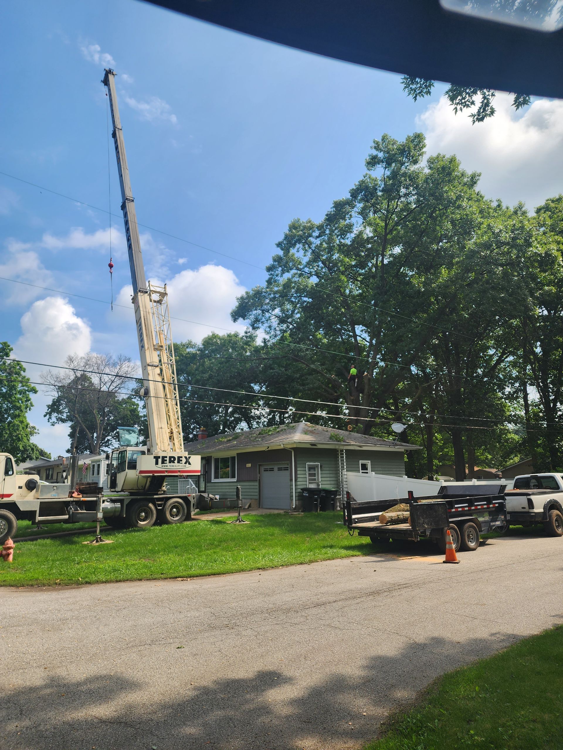 A large crane is sitting in front of a house Lake County, Indiana