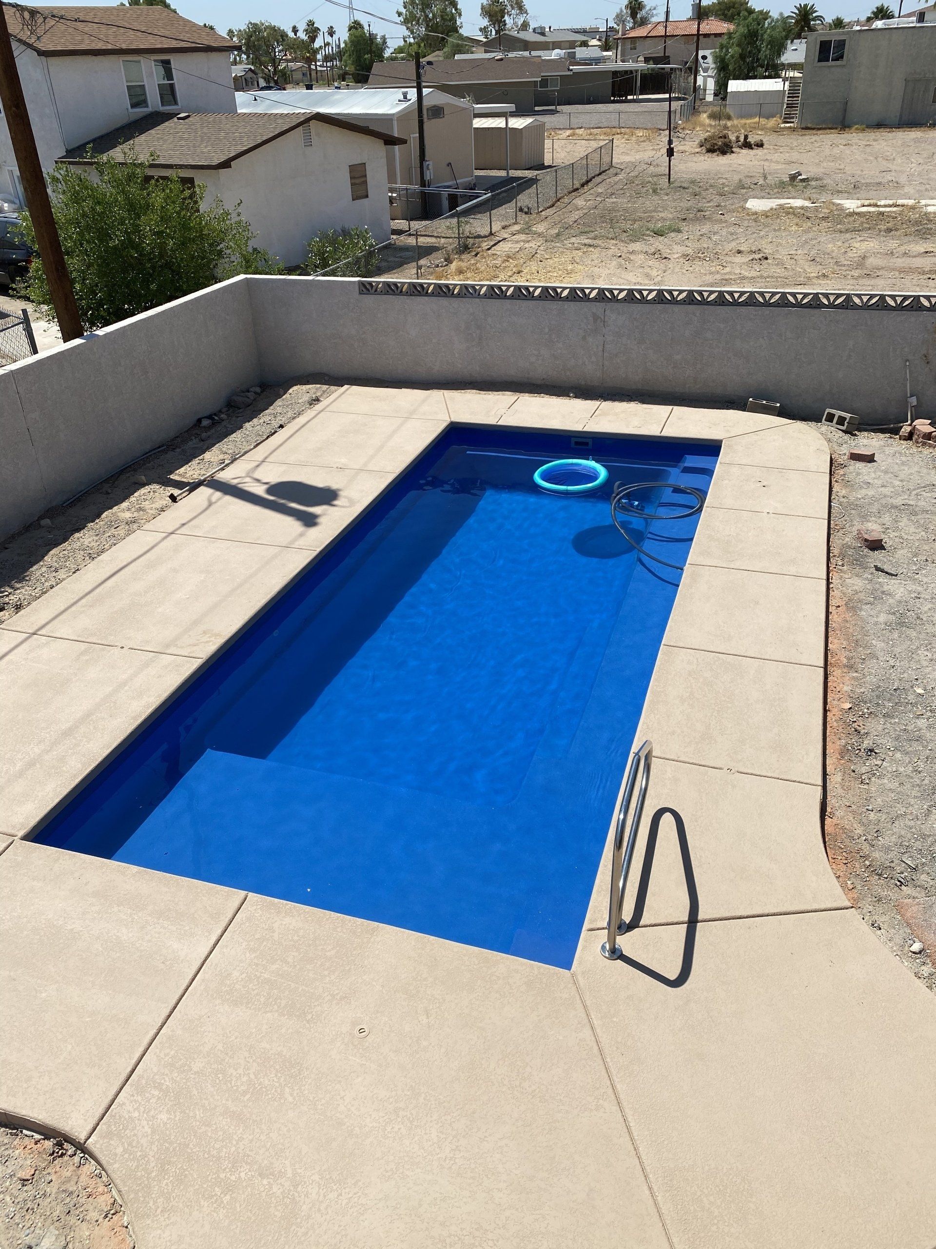 A small swimming pool with a life preserver in it