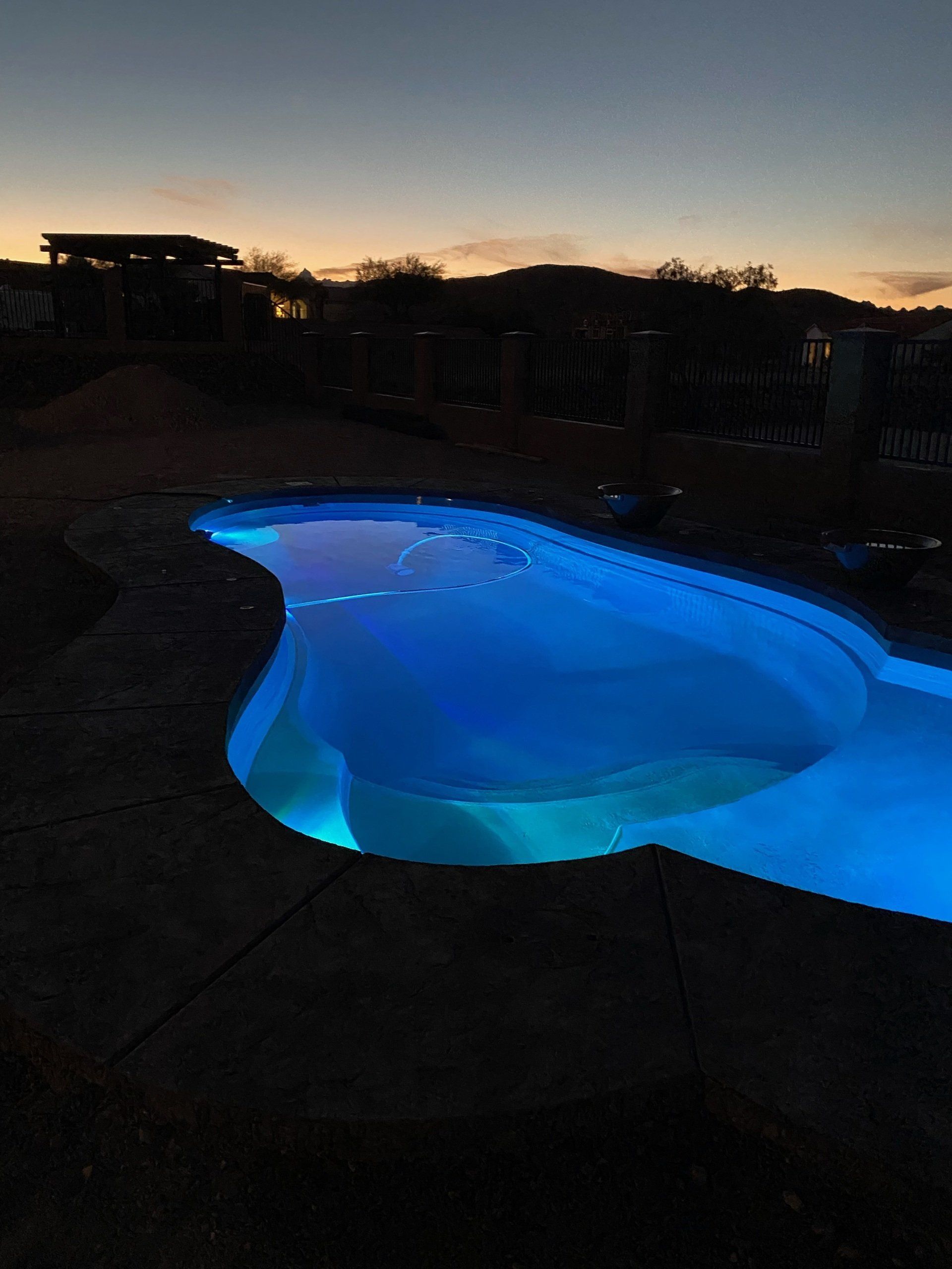 A large swimming pool is lit up at night
