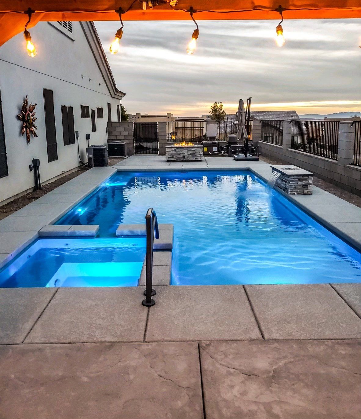 A large swimming pool is lit up with blue lights