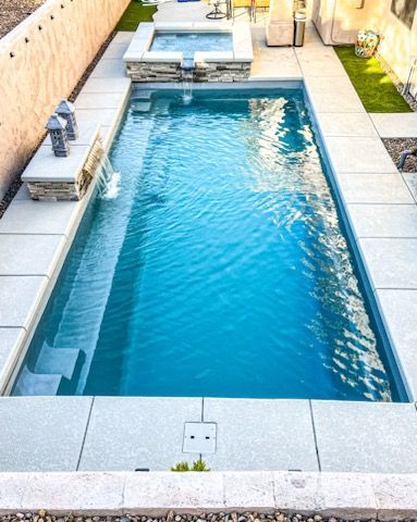 A small swimming pool with a fountain in the backyard