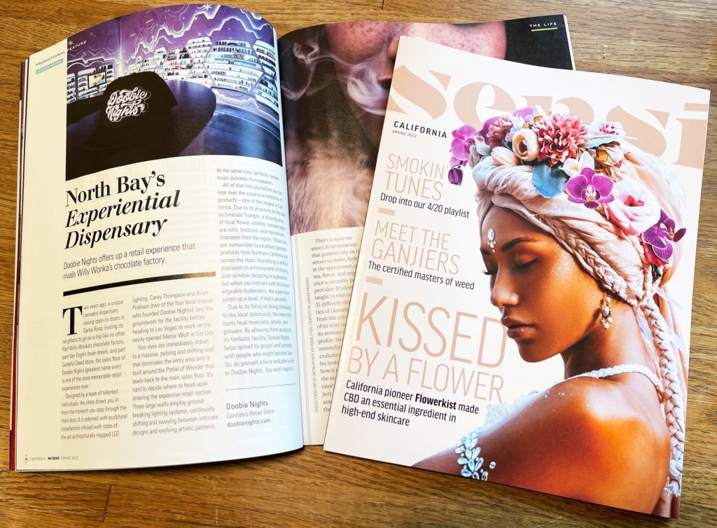 Magazine open to a page with text and an image of a city at night; the cover features a woman with flowers.