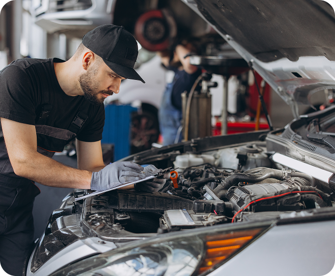 Mechanic inspecting a car engine with the hood open in an auto shop | A1 Brake & Service