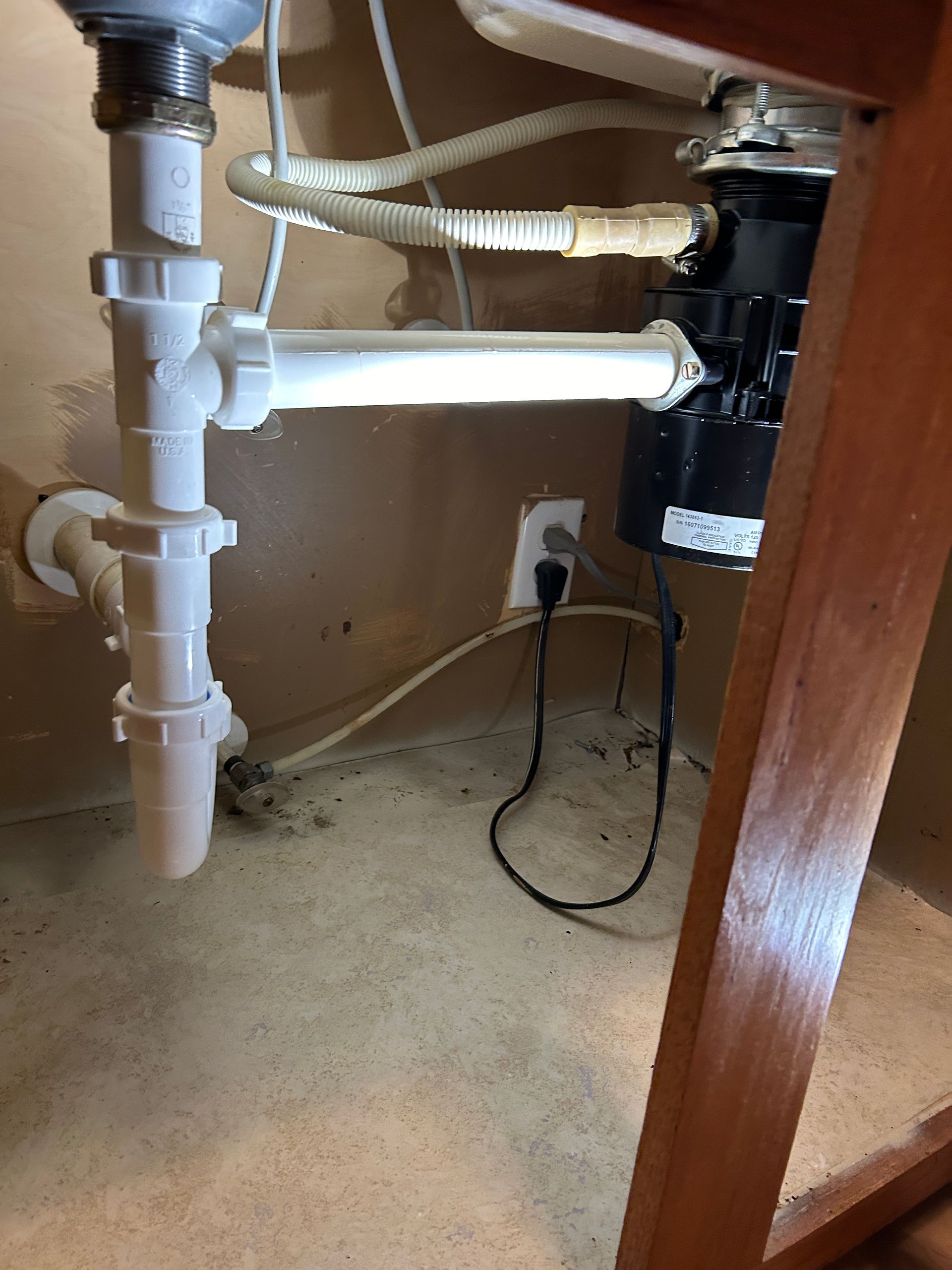 A sink with a garbage disposal underneath it.