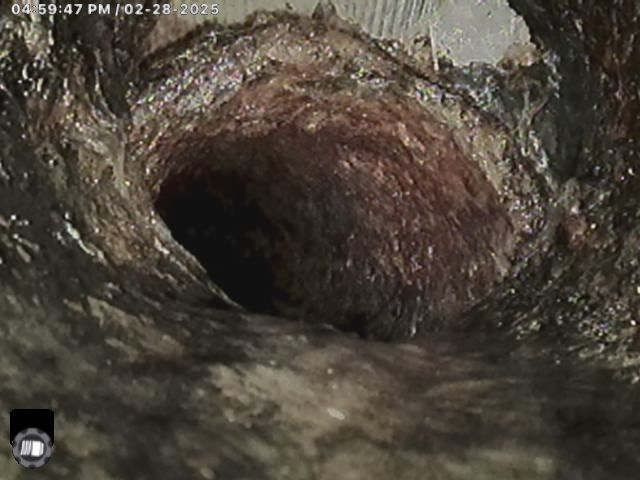 A close up of a hole in the ground with water coming out of it.