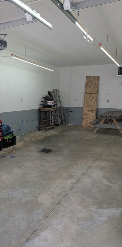 Speckled gray epoxy floor with a row of blue Lowe’s shopping carts in the background