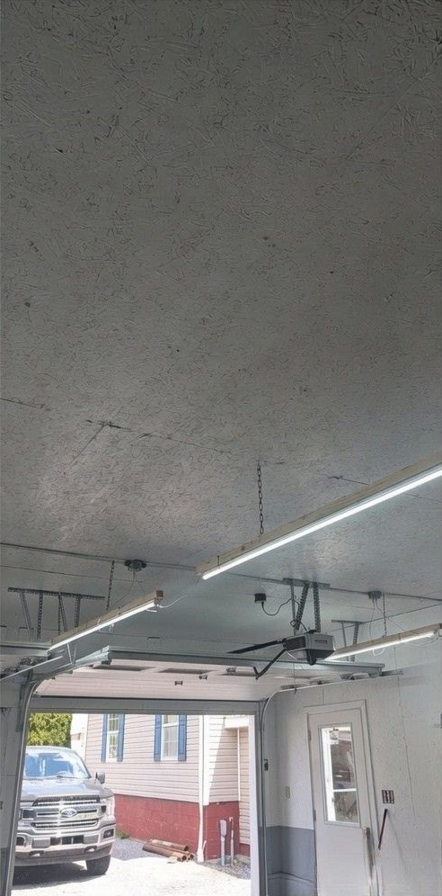 Shiny speckled epoxy floor in a bright room with open doors to a patio outside