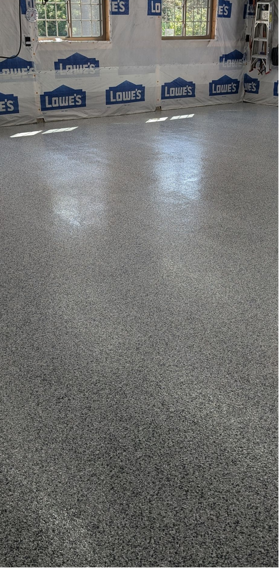 Speckled gray epoxy floor with a row of blue Lowe’s shopping carts in the background