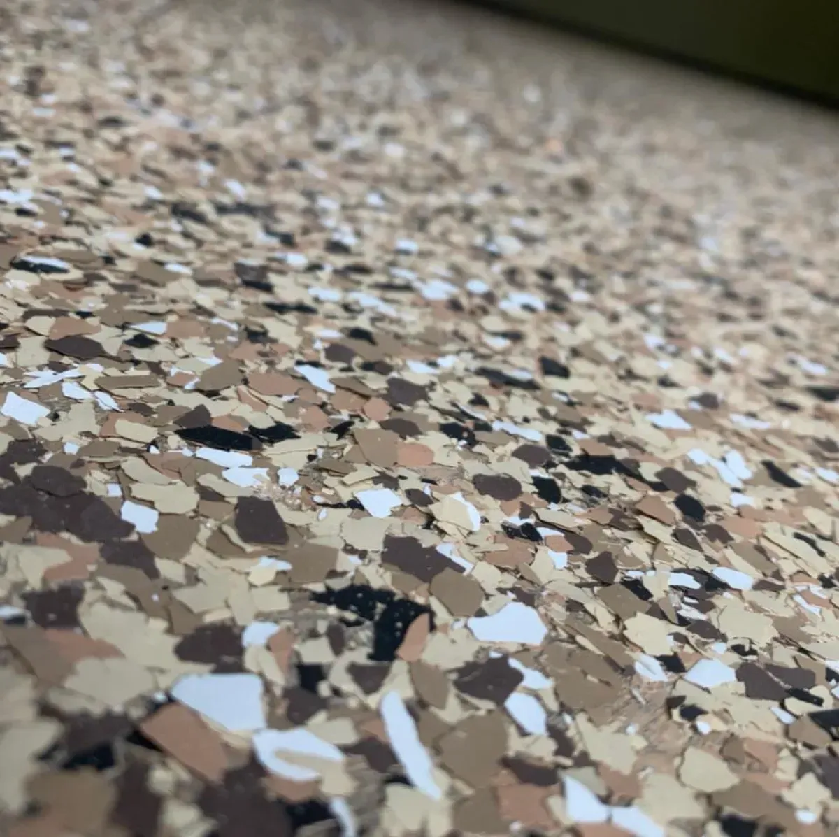 Close-up of speckled beige, brown, and black terrazzo flooring