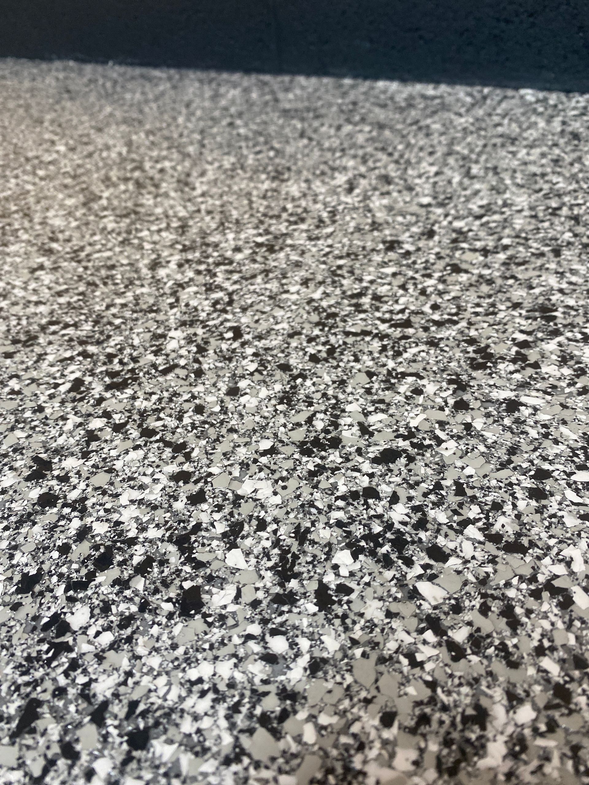 Close-up of a speckled gray, black, and white textured surface