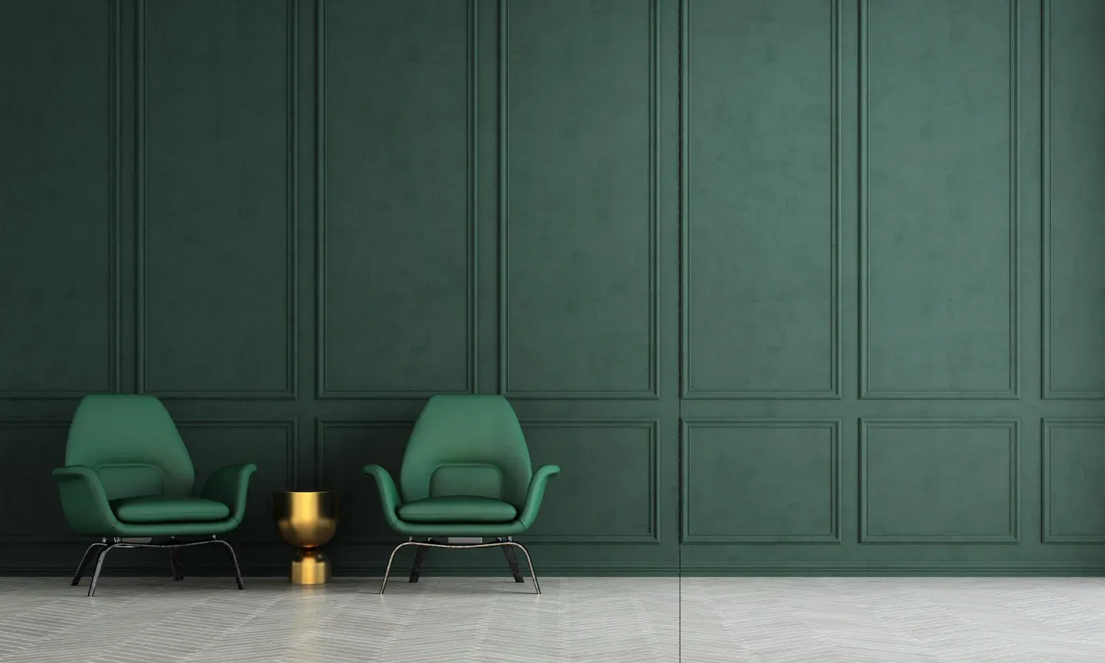 Two green armchairs and a small gold side table against a dark paneled wall in a minimalist room