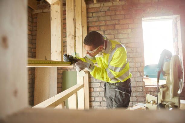 Contractor measuring timber on a construction site