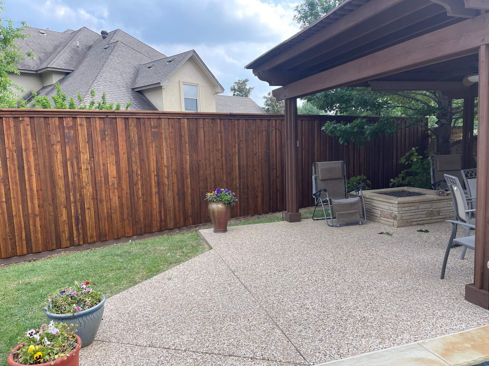 A Wooden Fence Surrounds a Patio
