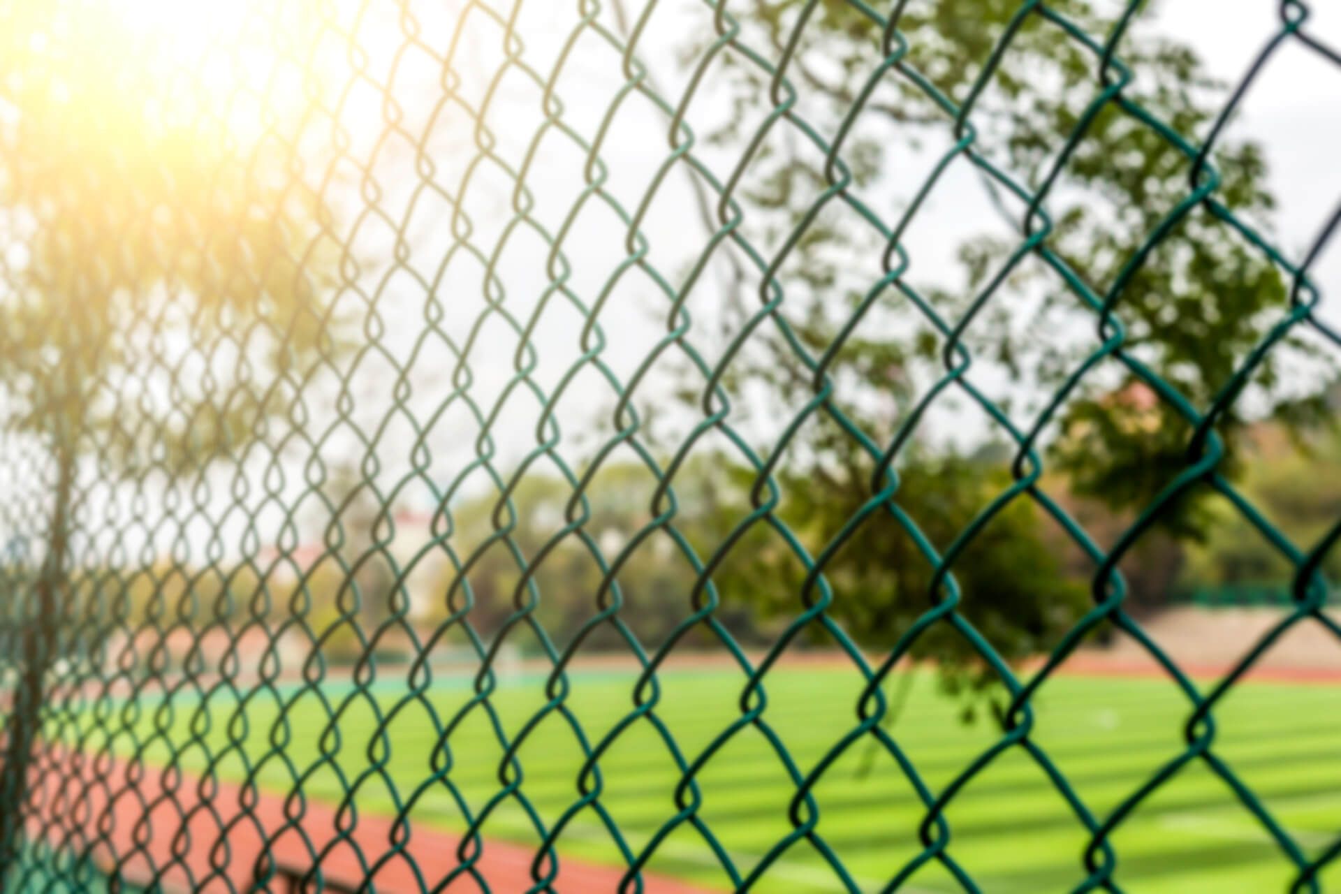 Chain Link Fence Surrounds a Baseball Field