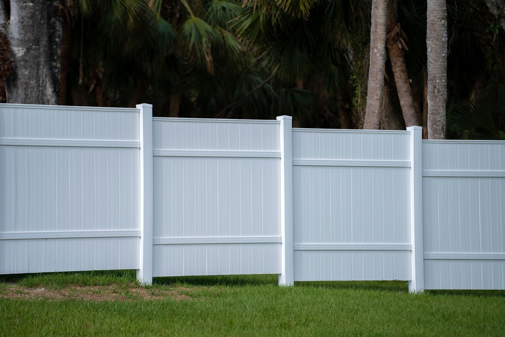 A Wooden Fence Is Sitting in The Middle of A Lush Green Yard