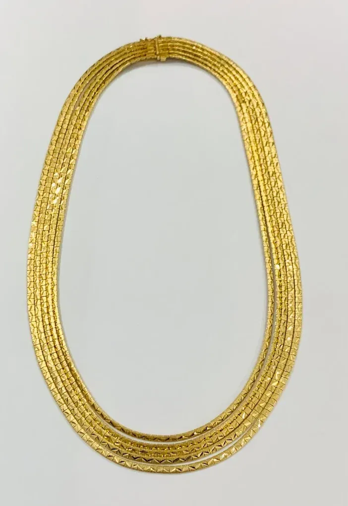 Gold multi-strand necklace on a white background