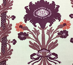 Fabric with repeating floral pattern in shades of purple and orange on a cream background.