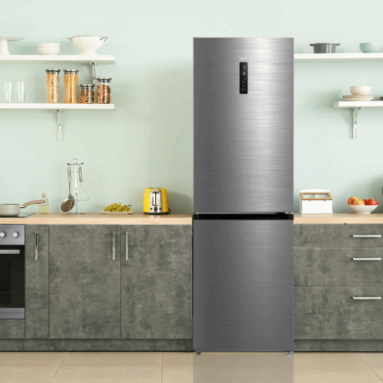 A kitchen with a stainless steel refrigerator and a toaster oven.