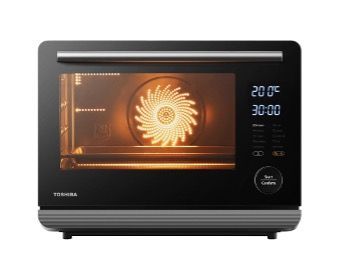 A toshiba toaster oven is being used to cook food.