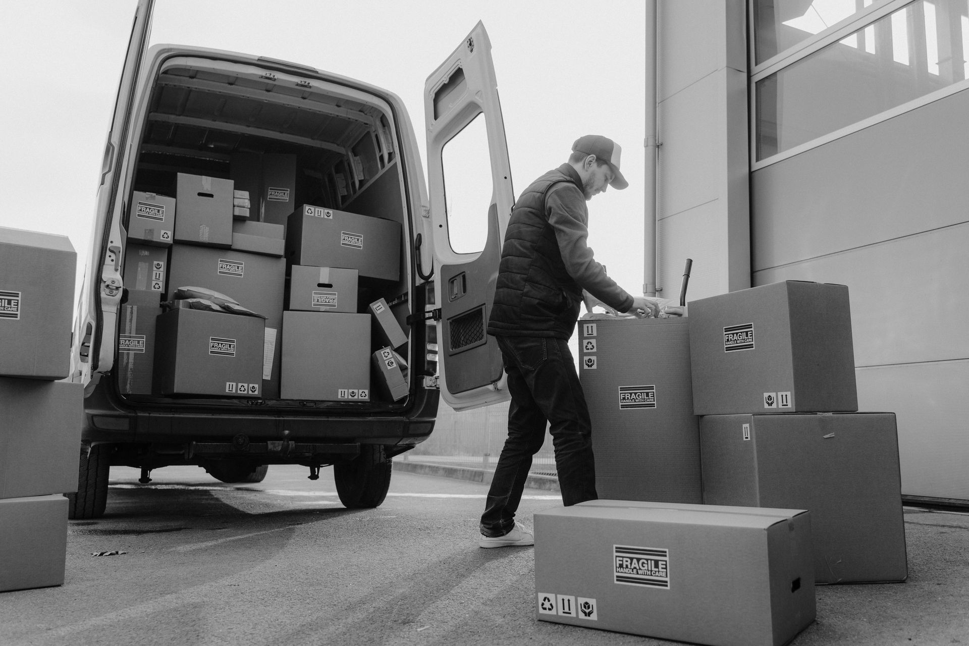 A man is loading boxes into a delivery van.