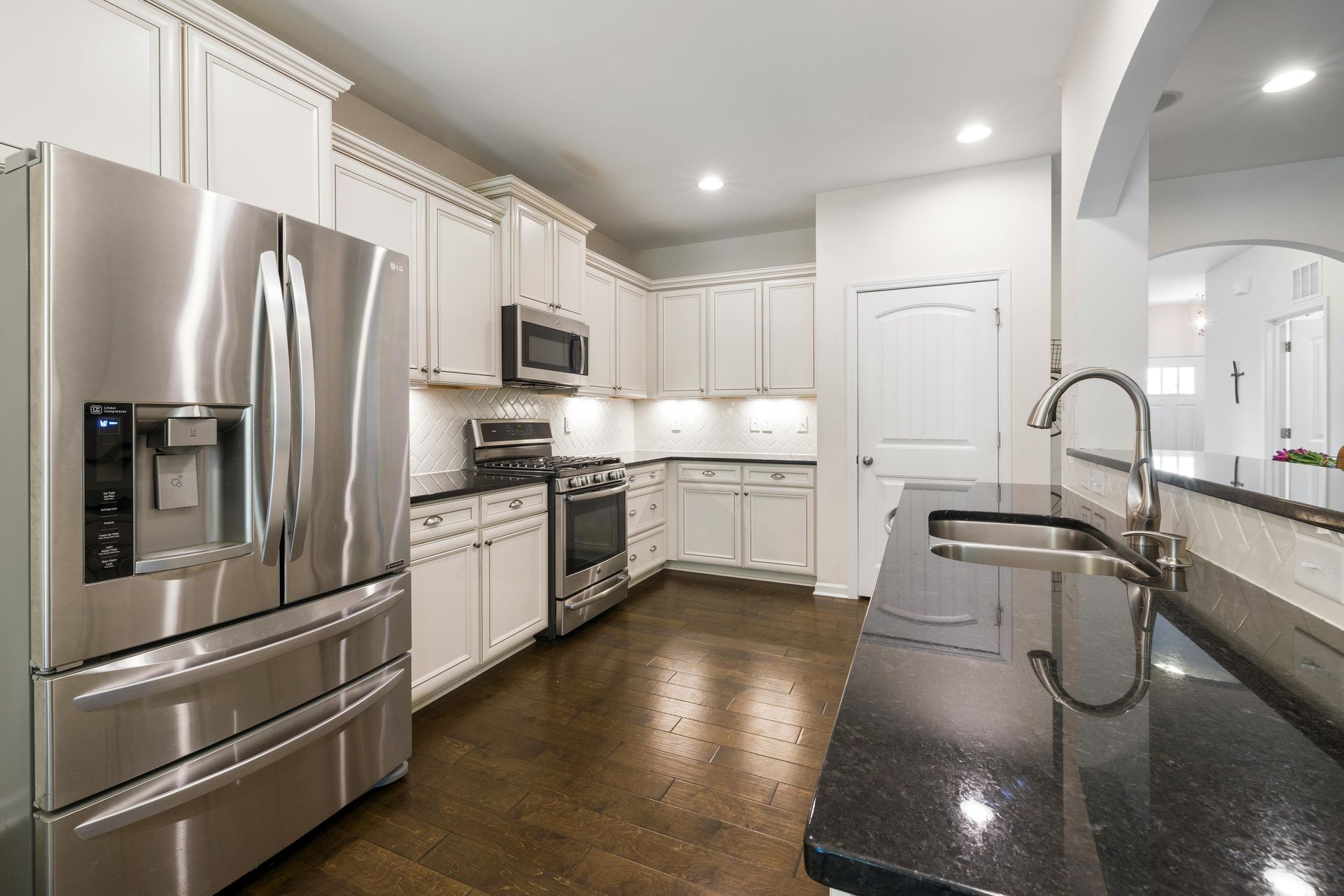 A kitchen with stainless steel appliances and granite counter tops.