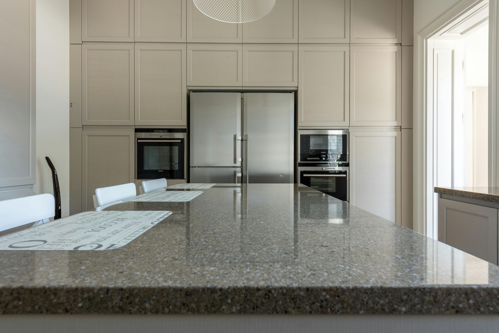 A kitchen with granite counter tops and stainless steel appliances.