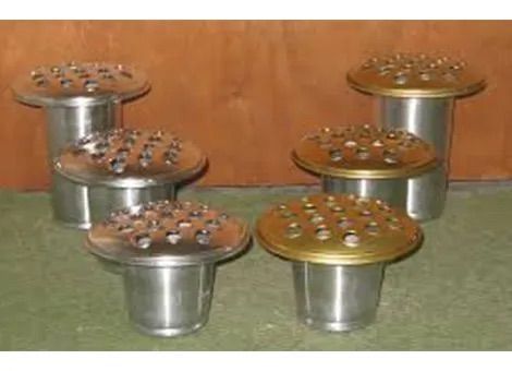 Five metal ashtrays with cigarettes arranged on a wooden surface against a brown background